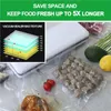 A vacuum sealer and various food items sealed in vacuum bags. Produktbild-Vorschau