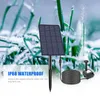 A solar-powered fountain pump kit is shown in a natural, outdoor setting with grass and water spray. Podgląd zdjęcia produktu
