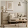 A modern living room with a beige sofa, a chest of drawers, a coffee table, and a framed picture on the wall. Produktbild-Vorschau