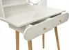 A close-up view of a white vanity table with wooden legs and two open drawers. Anteprima dell’immagine prodotto