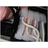 A close-up view of a printer's ink delivery system, showing tubes and cartridges. Produktbild-Vorschau