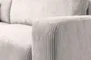 A close-up view of the textured fabric of a sofa armrest and cushions. Produktbild-Vorschau