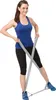 A woman is exercising with a fitness band. Produktbild-Vorschau