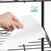 A hand is holding a white liner sheet over a black wire shelf. Produktbild-Vorschau
