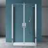 A modern shower enclosure with double doors, set against a teal wall and a concrete floor. Produktbild-Vorschau
