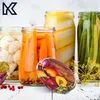 A collection of jars filled with pickled vegetables, including cauliflower, carrots, and green beans, arranged on a white surface. A decorative lid with a vegetable pattern is placed in the foreground. Voir les images du produit