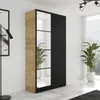 A modern wardrobe with a wood-effect finish and black doors, shown in a well-lit room with plants. Voir les images du produit