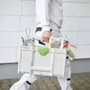 A person in white work clothes carries a Festool Systainer³ toolbox filled with various tools. Anteprima dell’immagine prodotto
