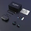 A flat lay of true wireless earbuds and their accessories on a dark surface. Produktbild-Vorschau