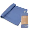 A rolled-up blue swaddle blanket is shown next to its packaging. Produktbild-Vorschau
