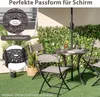 An outdoor patio scene with a table and chairs, surrounded by greenery. Náhled obrázku produktu