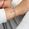 A close-up shot of a person's arm wearing a silver bracelet with a Thor's Hammer charm. Podgląd zdjęcia produktu