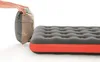 A person's hands are shown holding a rolled-up air mattress next to a partially inflated air mattress. Podgląd zdjęcia produktu
