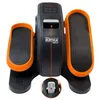 A mini elliptical trainer with orange pedals and a black console displaying digital readouts. Voir les images du produit