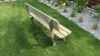 A wooden garden bench sits on a grassy lawn next to a bed of white gravel and plants. Produktbild-Vorschau
