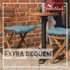 Two chairs with blue cushions are placed next to a small round table with a person sitting at it. Produktbild-Vorschau