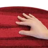 A hand is shown touching a red carpeted stair mat. Produktbild-Vorschau