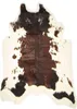 A cow-print rug on a white background. Podgląd zdjęcia produktu
