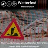 A construction site with orange safety netting and a warning sign depicting a person digging. Náhled obrázku produktu