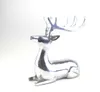 A polished silver aluminum figurine of a lying deer with antlers, set against a white background. Produktbild-Vorschau