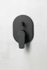A black matte shower faucet is mounted on a textured light gray and white wall. Náhled obrázku produktu