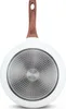 The underside of a white frying pan with a wooden handle and a textured metal base. Produktbild-Vorschau