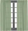 A pair of light green sheer curtains hanging in front of a dark wooden window frame. Produktbild-Vorschau