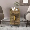 A wooden nightstand with a gold handle sits between two chairs, with a vase and a cup on top. Podgląd zdjęcia produktu