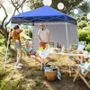 People enjoying a picnic under a blue canopy tent. Podgląd zdjęcia produktu