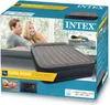 The image shows a product box for an Intex Dura-Beam air mattress. The box features images of a couple relaxing and someone sleeping on the mattress, as well as text describing its features and dimensions. Náhled obrázku produktu