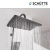 A close-up of a modern dark gray square shower head with water spraying from it. Anteprima dell’immagine prodotto