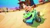 Patrick Star is driving a green alligator-shaped kart in a desert-like environment with tents and buildings in the background. Náhled obrázku produktu