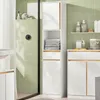 A modern bathroom with green tiled walls, featuring a tall white cabinet with wood accents, a shower enclosure, and a vanity unit. Anteprima dell’immagine prodotto