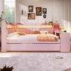 A pink daybed with storage and LED lighting, styled with pillows and a throw blanket, in a bedroom setting. Náhľad obrázku produktu