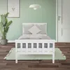 A white wooden children's bed with gray pillows and a green rug in a room with light green walls. Náhľad obrázku produktu