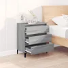 A grey wooden sideboard with three open drawers is placed next to a bed. Podgląd zdjęcia produktu