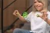 A young girl playing with a spinning toy. Produktbild-Vorschau