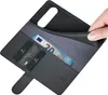 A hand is shown holding open a black leather wallet-style phone case, revealing credit cards and a 20 Euro banknote inside. Produktbild-Vorschau