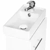 A white bathroom vanity with a sink and faucet. Náhled obrázku produktu