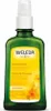 A green glass bottle of Weleda massage oil with a yellow label featuring images of calendula flowers. Anteprima dell’immagine prodotto