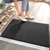 A person is putting on shoes next to a shoe rack, with a doormat in the foreground. Podgląd zdjęcia produktu