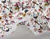 A close-up view of a white duvet cover with a floral and bird pattern, showing a zipper. Produktbild-Vorschau