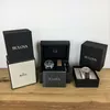 Two Bulova watch boxes are displayed on a wooden surface against a white background. Produktbild-Vorschau