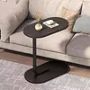 Dunkelbrauner C-förmiger Beistelltisch mit ovaler Platte und Sockel, neben einem hellgrauen Sofa platziert Voir les images du produit