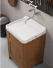 A washing basin with a cabinet underneath, a faucet, and a tool rack on the wall. Náhled obrázku produktu