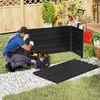 A man is assembling a black metal raised garden bed in a backyard setting. Voir les images du produit
