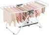A white metal drying rack with clothes hanging on it, and a pair of white sneakers on the bottom rack. Produktbild-Vorschau