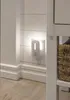A night light plugged into a wall outlet on a shiplap wall. Podgląd zdjęcia produktu