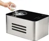 A hand pouring milk into an ice cream maker. Produktbild-Vorschau