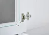 A close-up view of a cabinet hinge on a white cabinet door. Produktbild-Vorschau